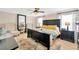 Main bedroom with a large bed, two bedside tables, a ceiling fan and two windows at 2022 Hawks View Dr, Ruskin, FL 33570