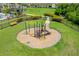Community playground showcasing a fun play structure with slide, set within a grassy fenced area at 2022 Hawks View Dr, Ruskin, FL 33570