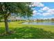 Relaxing view of the pond, surrounded by lush green lawn at 2022 Hawks View Dr, Ruskin, FL 33570