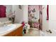 Bathroom featuring a single sink vanity, toilet with adapted seat, and a butterfly-themed shower curtain at 22798 Penny Loop, Land O Lakes, FL 34639