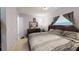 Bedroom boasts calming lilac walls, tile floors, and a comfortable bed with neutral bedding under natural lighting at 22798 Penny Loop, Land O Lakes, FL 34639
