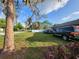 The spacious front yard with mature trees offers ample parking and a picturesque neighborhood setting at 22798 Penny Loop, Land O Lakes, FL 34639