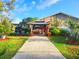 Inviting home exterior with a charming gazebo, well-manicured lawn, and convenient covered parking at 22798 Penny Loop, Land O Lakes, FL 34639