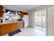 Kitchen showcasing wood cabinets, stainless steel sink, white refrigerator and a sliding glass door to the backyard at 22798 Penny Loop, Land O Lakes, FL 34639