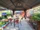 Outdoor patio with a gazebo, dining table and chairs, and lush potted plants for a relaxing backyard retreat at 22798 Penny Loop, Land O Lakes, FL 34639