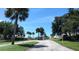 Gated community entrance with lush landscaping and well-maintained grounds at 26 Harborpointe Dr, Port Richey, FL 34668