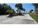 Elegant gated community entrance adorned with lush landscaping and decorative signage, offering exclusivity at 26 Harborpointe Dr, Port Richey, FL 34668