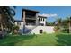 A modern home with a multi-level design, balconies, and lush tropical landscaping at 26 Harborpointe Dr, Port Richey, FL 34668