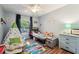 Playful bedroom with hardwood floors, a teepee, and ample natural light, creating an inviting ' space at 2714 Witley Ave, Palm Harbor, FL 34685
