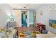 Charming room features a sliding barn door, colorful rug, and playful dinosaur decor at 2714 Witley Ave, Palm Harbor, FL 34685
