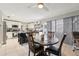 Inviting dining area with a dark wood table set next to an open, bright kitchen featuring white cabinets at 2714 Witley Ave, Palm Harbor, FL 34685