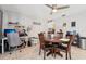 Cozy dining area features a dark wood table set, a ceiling fan, and blends seamlessly with the adjacent office setup at 2714 Witley Ave, Palm Harbor, FL 34685