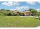 Well-maintained one-story home with manicured lawn and mature landscaping at 2714 Witley Ave, Palm Harbor, FL 34685