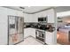 Modern kitchen with stainless steel appliances, white cabinets, and dark countertops for a sleek, updated look at 2714 Witley Ave, Palm Harbor, FL 34685