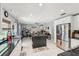 Open-concept kitchen flows into a dining area and office, featuring an island and modern appliances at 2714 Witley Ave, Palm Harbor, FL 34685