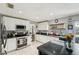 Bright kitchen featuring white cabinets, dark countertops, stainless steel appliances, and recessed lighting at 2714 Witley Ave, Palm Harbor, FL 34685