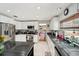 Bright kitchen featuring white cabinets, dark countertops, stainless steel appliances, and an island at 2714 Witley Ave, Palm Harbor, FL 34685