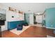 Open living area with built-in cabinets, hardwood flooring, and an adjacent front entrance at 2714 Witley Ave, Palm Harbor, FL 34685