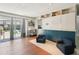 Bright living area with hardwood floors, built-in storage, and sliding door access to pool at 2714 Witley Ave, Palm Harbor, FL 34685