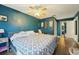 Spacious main bedroom featuring wood-look floors, ceiling fan, and ensuite bathroom access at 2714 Witley Ave, Palm Harbor, FL 34685