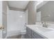 Bathroom features a white shower/tub combo, gray walls, vanity and marbled countertop at 2957 Hickory Grove Dr, Valrico, FL 33596