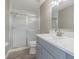 Bathroom featuring gray walls, vanity, marbled countertop, toilet and glass enclosed shower at 2957 Hickory Grove Dr, Valrico, FL 33596