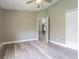 A bedroom with hard surface flooring, a ceiling fan, and neutral colored walls at 2957 Hickory Grove Dr, Valrico, FL 33596