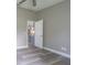 Bedroom featuring hard surface floors, neutral colored walls, and view into the kitchen at 2957 Hickory Grove Dr, Valrico, FL 33596