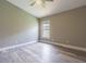 Bedroom features a ceiling fan, light gray paint, wood-look flooring, and natural light at 2957 Hickory Grove Dr, Valrico, FL 33596