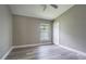 Bedroom features a ceiling fan, gray walls, hard surface floors and a window at 2957 Hickory Grove Dr, Valrico, FL 33596