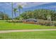 Well-manicured entrance to Twin Lakes of Brandon featuring lush landscaping and signage at 2957 Hickory Grove Dr, Valrico, FL 33596