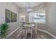 Cozy dining area with a modern chandelier, neutral decor, and a view to the backyard at 2957 Hickory Grove Dr, Valrico, FL 33596