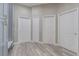Hallway with gray cabinets and a bench leading to multiple doors at 2957 Hickory Grove Dr, Valrico, FL 33596