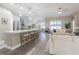 Open-concept kitchen with a large island, bar stool seating, and stainless steel appliances at 2957 Hickory Grove Dr, Valrico, FL 33596