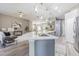 Open-concept kitchen and living area with a large island featuring a marble countertop at 2957 Hickory Grove Dr, Valrico, FL 33596