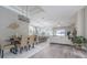 Bright, open-concept living space with modern lighting, wood floors, and a connected kitchen at 2957 Hickory Grove Dr, Valrico, FL 33596