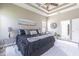 Comfortable main bedroom with tray ceiling, neutral tones, and ample natural light at 2957 Hickory Grove Dr, Valrico, FL 33596