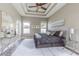 Tranquil main bedroom with tray ceiling, soft carpet, and stylish furnishings at 2957 Hickory Grove Dr, Valrico, FL 33596