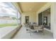 Serene screened-in patio features comfortable seating and views of the backyard and neighborhood at 2957 Hickory Grove Dr, Valrico, FL 33596