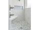 Modern shower features marble tile, a built-in seat, and a niche for storage at 2957 Hickory Grove Dr, Valrico, FL 33596