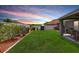Manicured backyard features a white fence, trimmed shrubbery, and a covered patio, ideal for outdoor enjoyment at 31349 Philmar Ln, Wesley Chapel, FL 33543