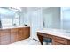 Bathroom featuring wooden cabinets, double sinks, tile flooring, and a vanity area with a stool at 31349 Philmar Ln, Wesley Chapel, FL 33543