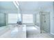 Bright bathroom with double sinks, a soaking tub, a glass enclosed shower, and ample natural light at 31349 Philmar Ln, Wesley Chapel, FL 33543
