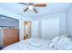 Comfortable bedroom featuring a ceiling fan, closet, and warm natural light at 31349 Philmar Ln, Wesley Chapel, FL 33543