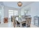 View of formal dining room with six wood chairs, a foosball table, and overhead lighting at 31349 Philmar Ln, Wesley Chapel, FL 33543