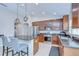 Bright kitchen with stainless steel appliances and center island with granite countertops and seating at 31349 Philmar Ln, Wesley Chapel, FL 33543
