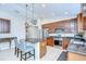 Kitchen with stainless steel appliances, granite countertops, island and decorative hanging lights at 31349 Philmar Ln, Wesley Chapel, FL 33543