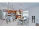 Open kitchen features wooden cabinets, stainless steel appliances, breakfast bar, and adjacent dining area at 31349 Philmar Ln, Wesley Chapel, FL 33543