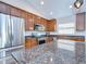 Close-up of kitchen with stainless steel appliances, granite countertops and view of the island at 31349 Philmar Ln, Wesley Chapel, FL 33543