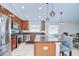Spacious kitchen with stainless steel appliances, granite countertops, and a center island with seating at 31349 Philmar Ln, Wesley Chapel, FL 33543